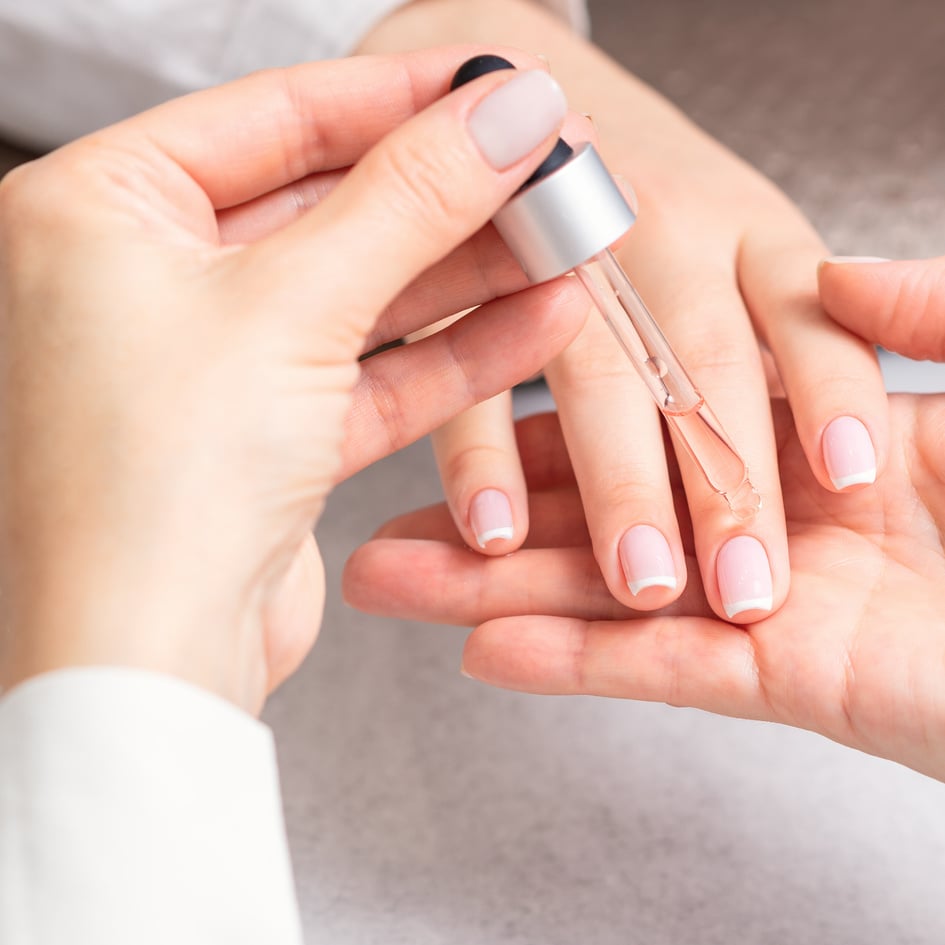 Manicurist Pours Oil on Nails of Woman